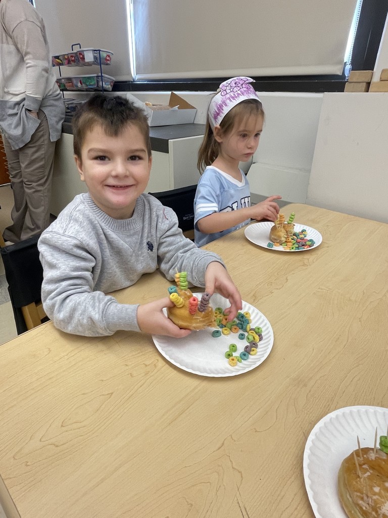 students sitting at a table working with food
