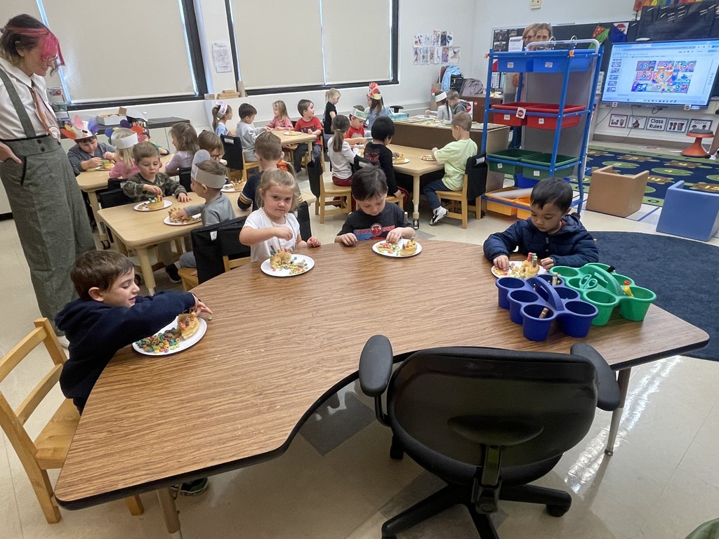 students sitting at a table working with food