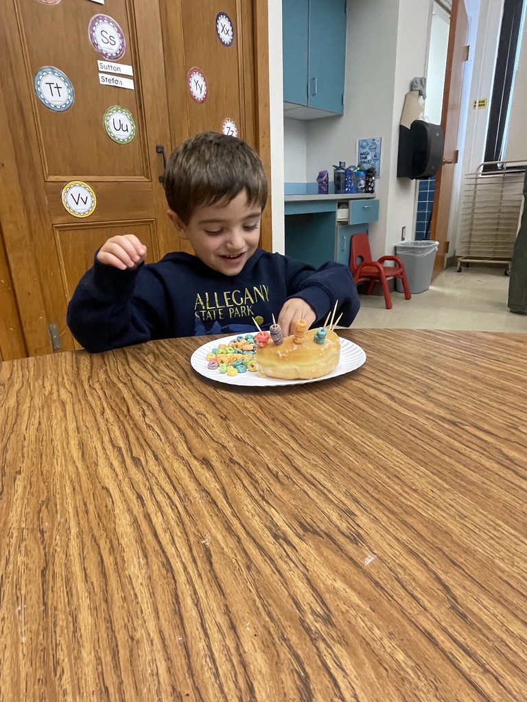 student sitting at a table working with food