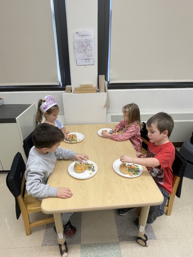 students sitting at a table working with food