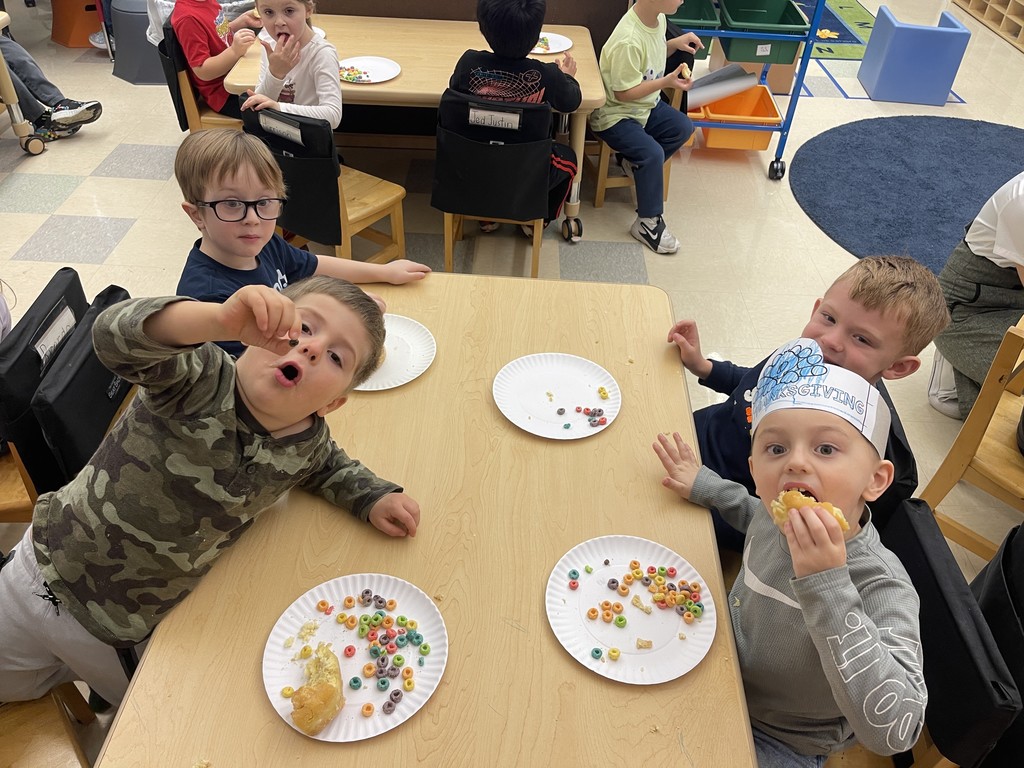 students sitting at a table eating