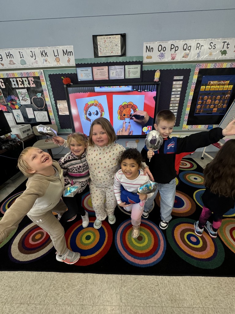students holding balloons in their classroom
