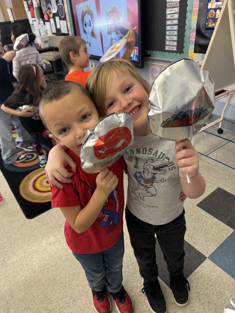two students holding balloons