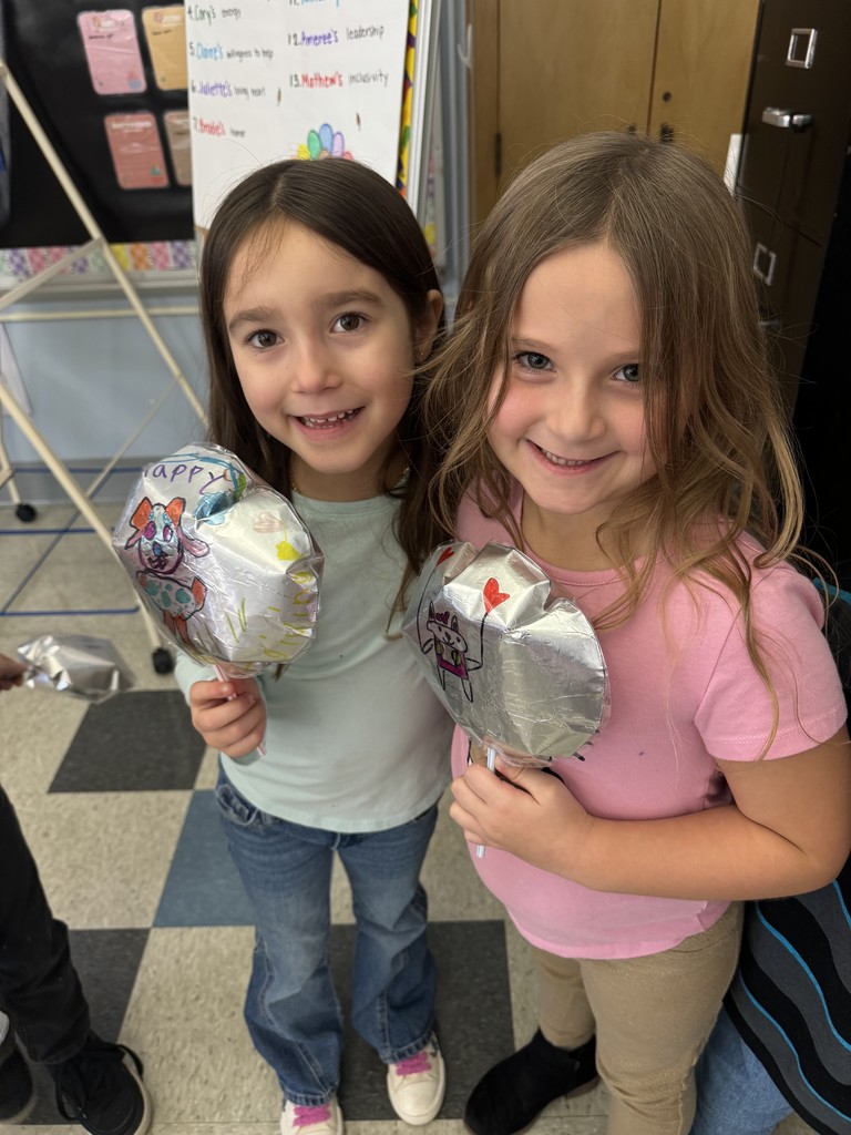 two students holding balloons
