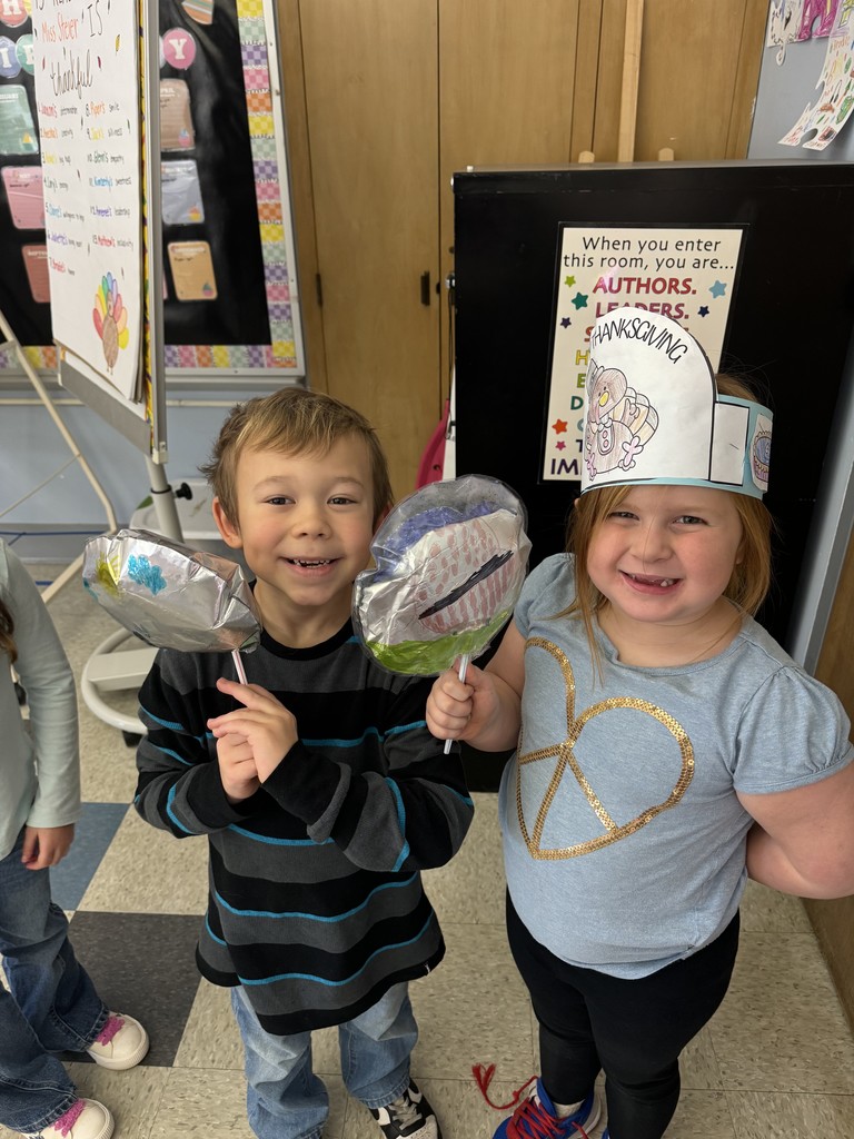 two students holding balloons