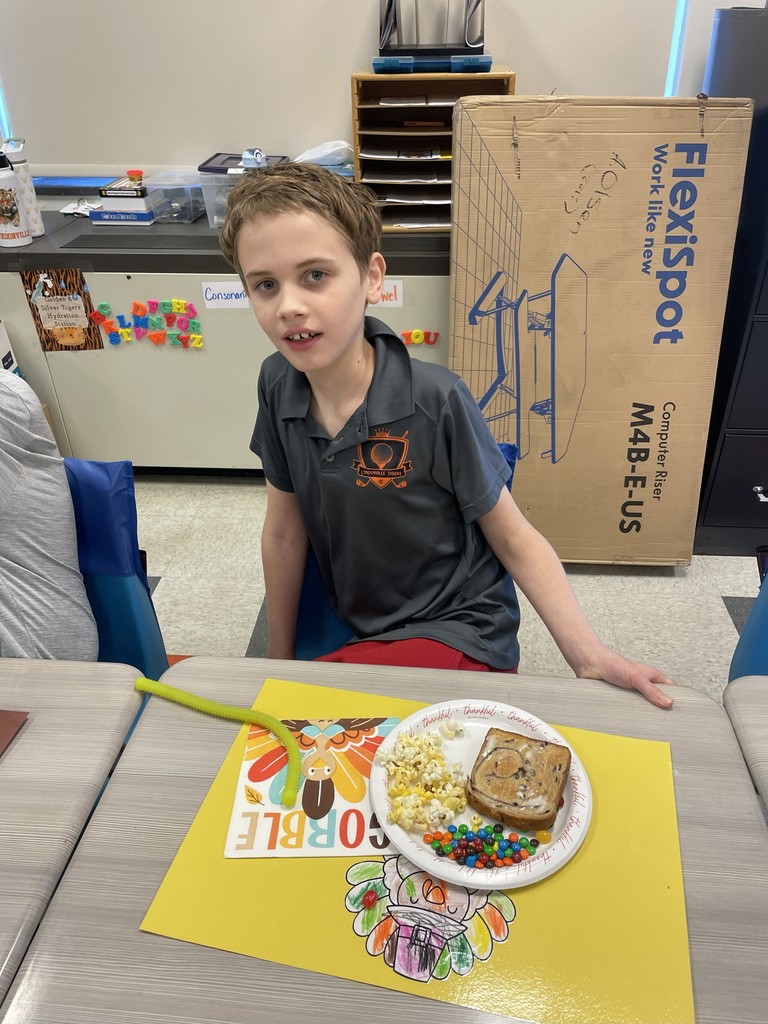 student sitting at table with a plate of food