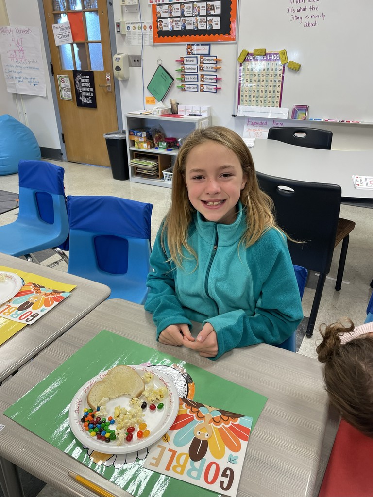 student sitting at table with a plate of food