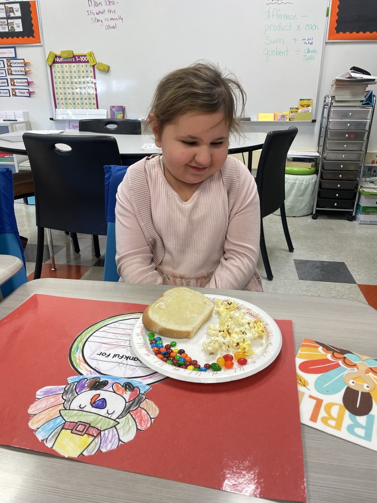 student sitting at table with a plate of food