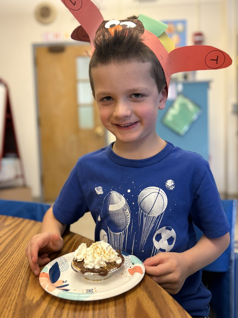 boy sitting with pie at table
