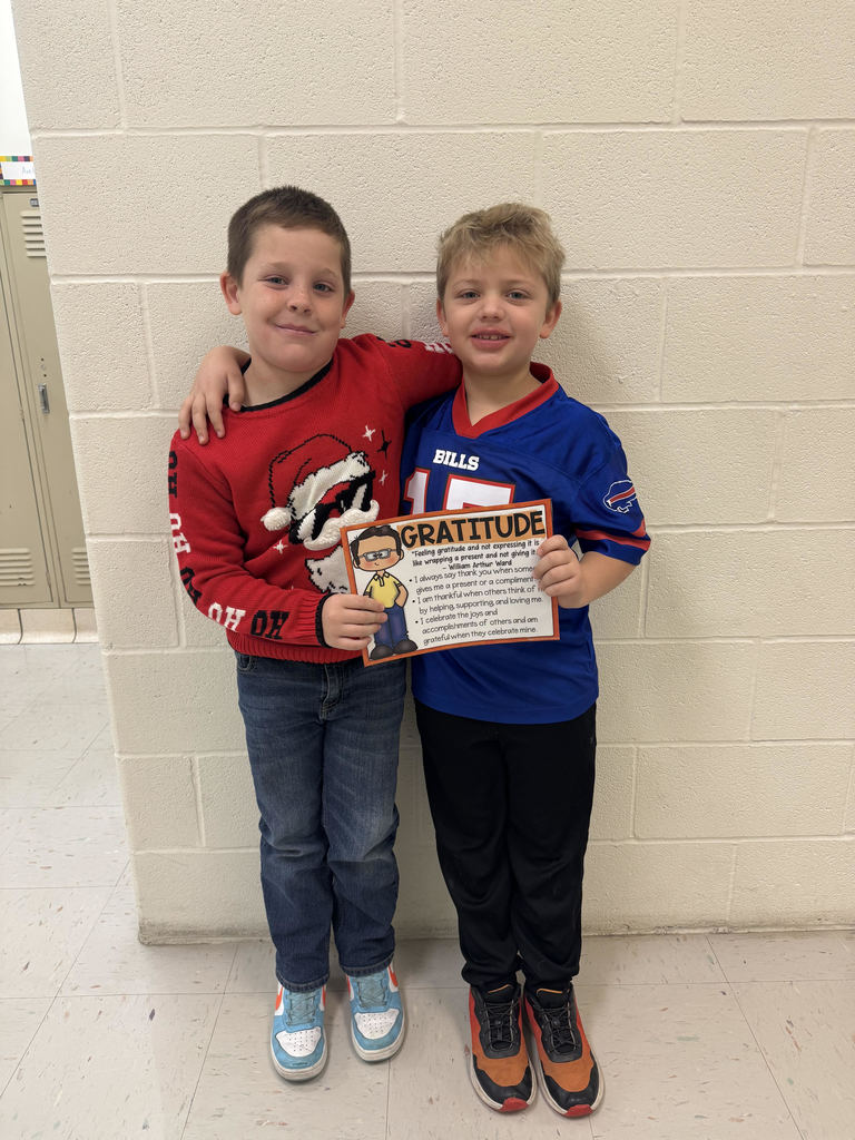 two goys standing together holding a certificate