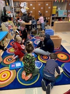 students seated on the floor doing an activity