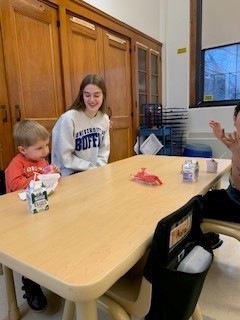 students seated at table doing an activity