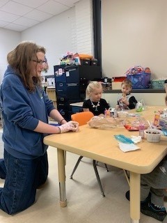 students seated at table doing an activity