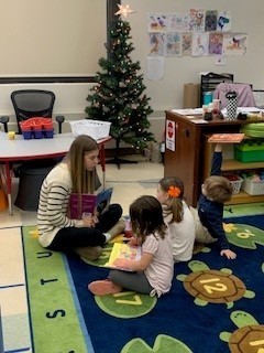 students seated on the floor reading books