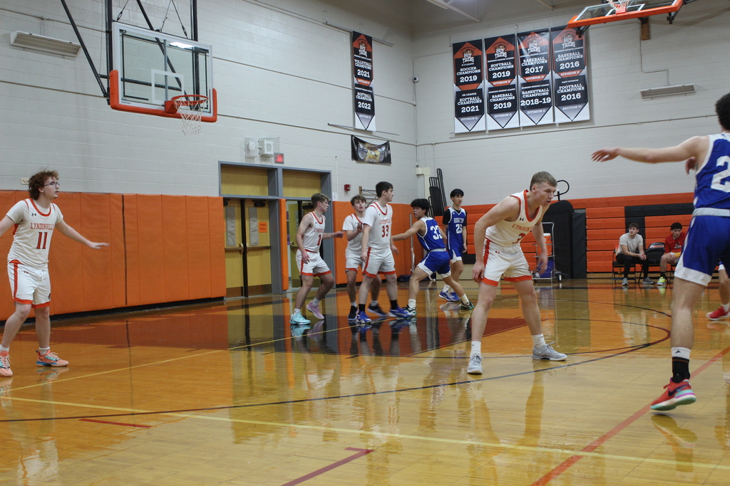 boys playing basketball in gym