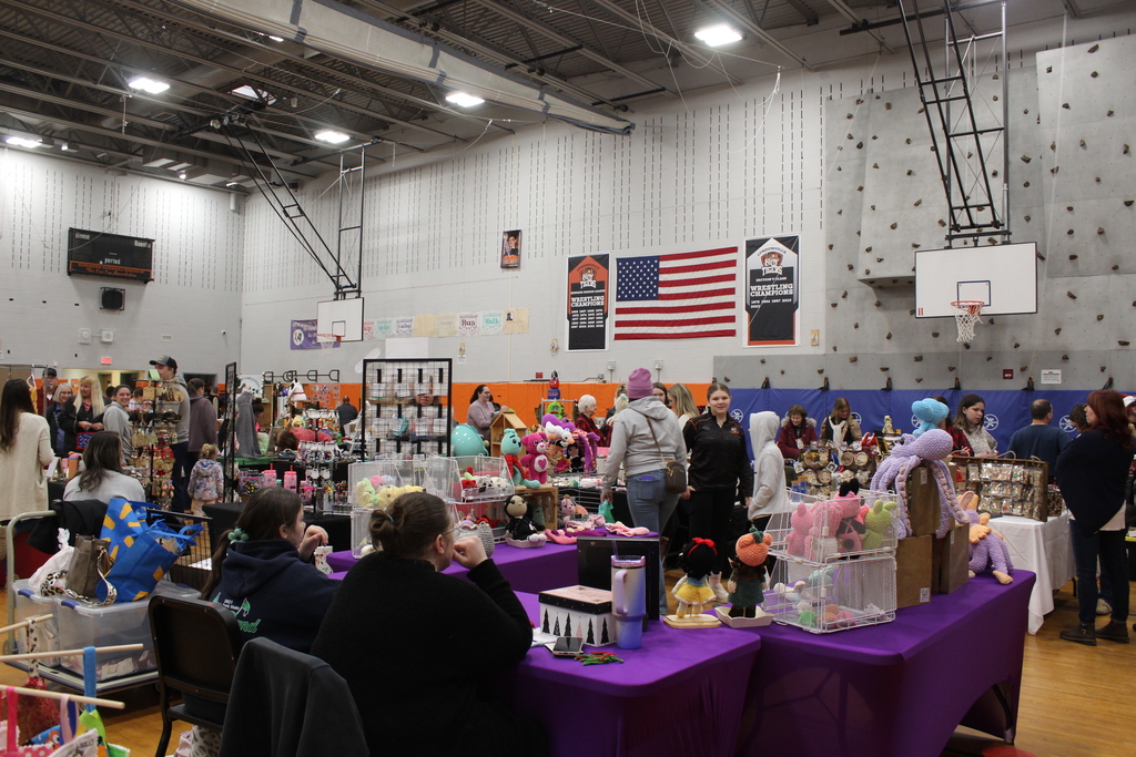 people shopping craft sale in the gym