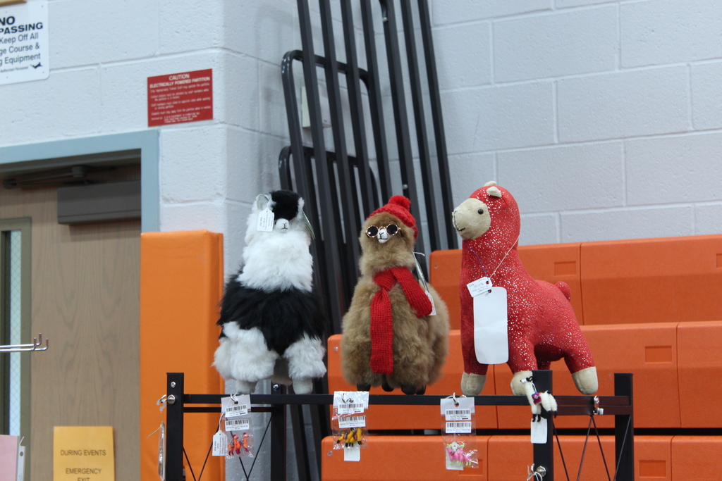 three llama stuffed animals in various outfits