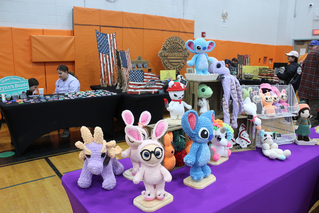 knitted creatures on display at a booth