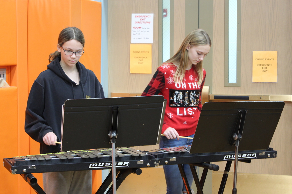 two students playing xylophones