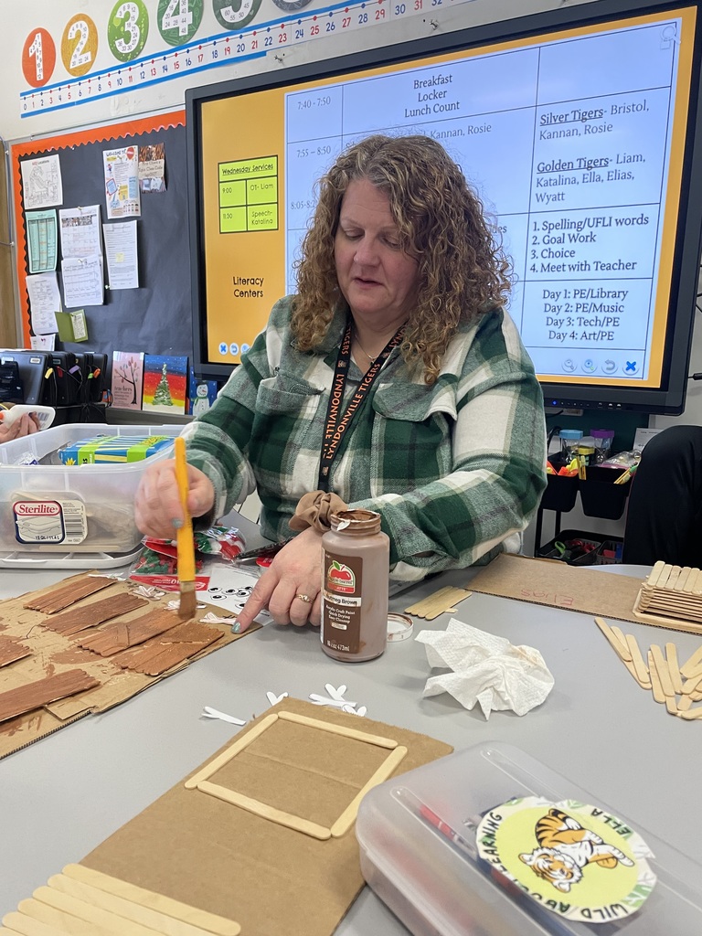 teacher working on a project at a table