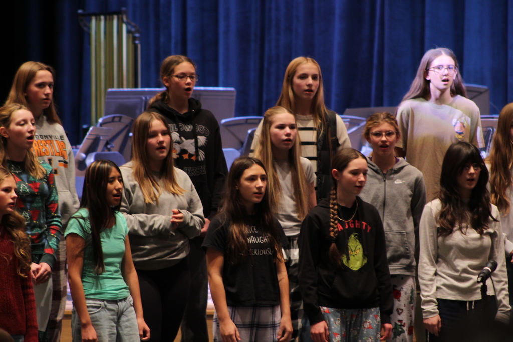 students singing in choir on risers