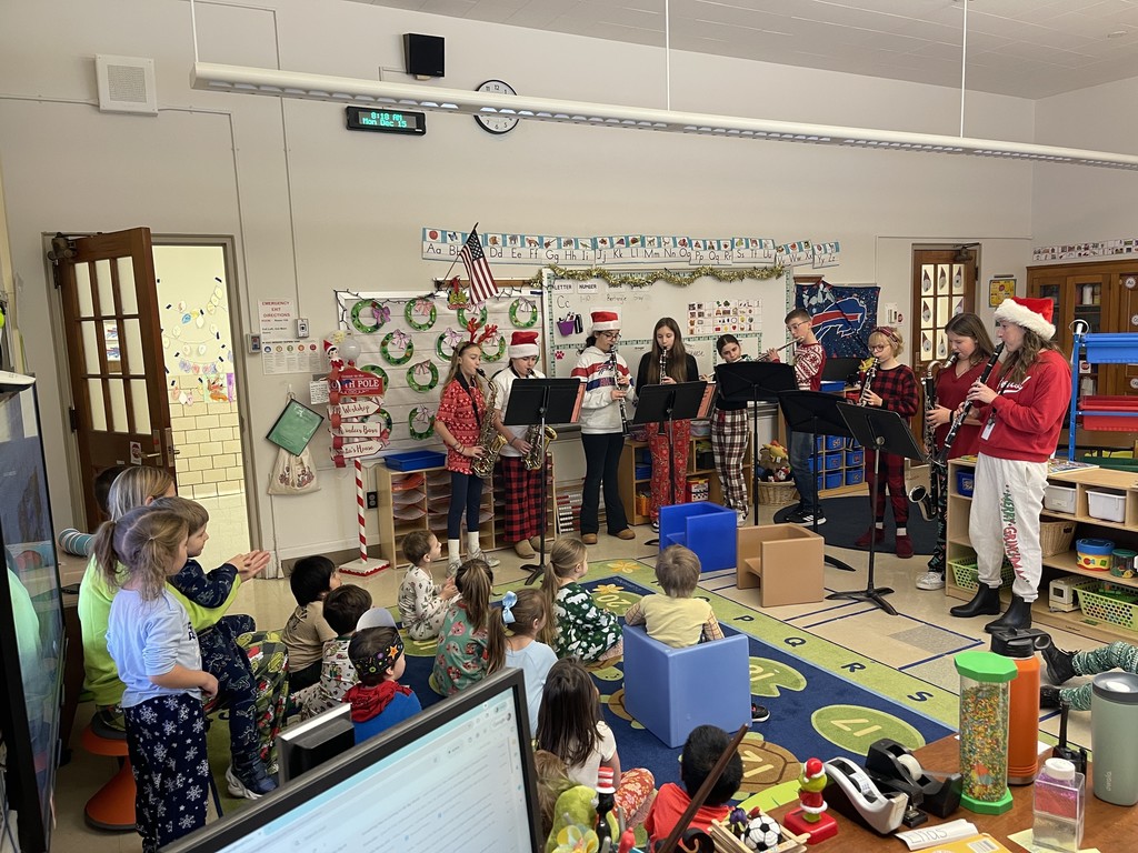 students playing instruments in classroom for younger students