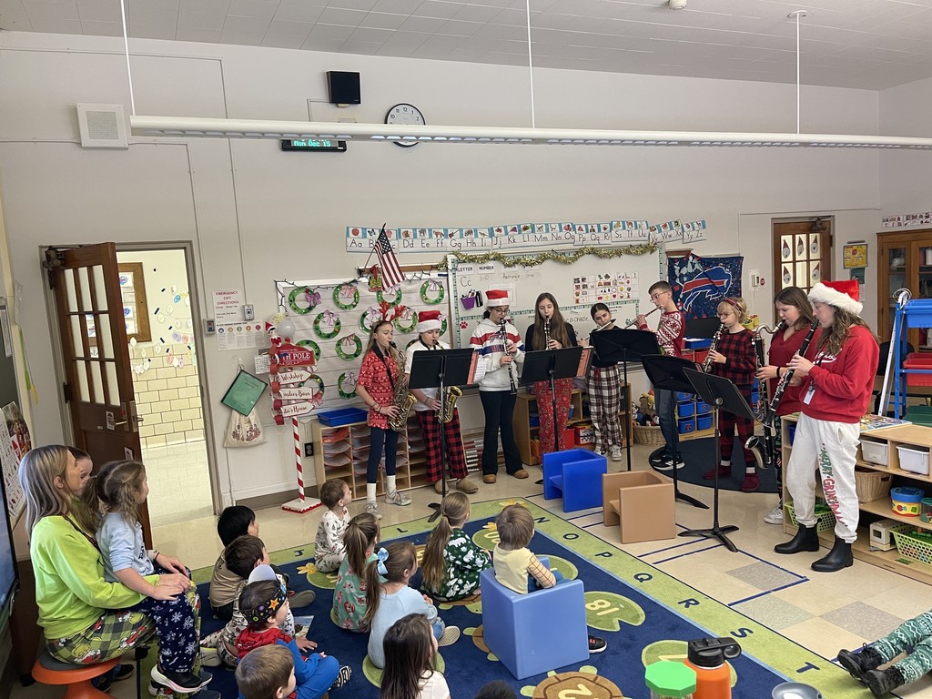 students playing instruments in classroom for younger students