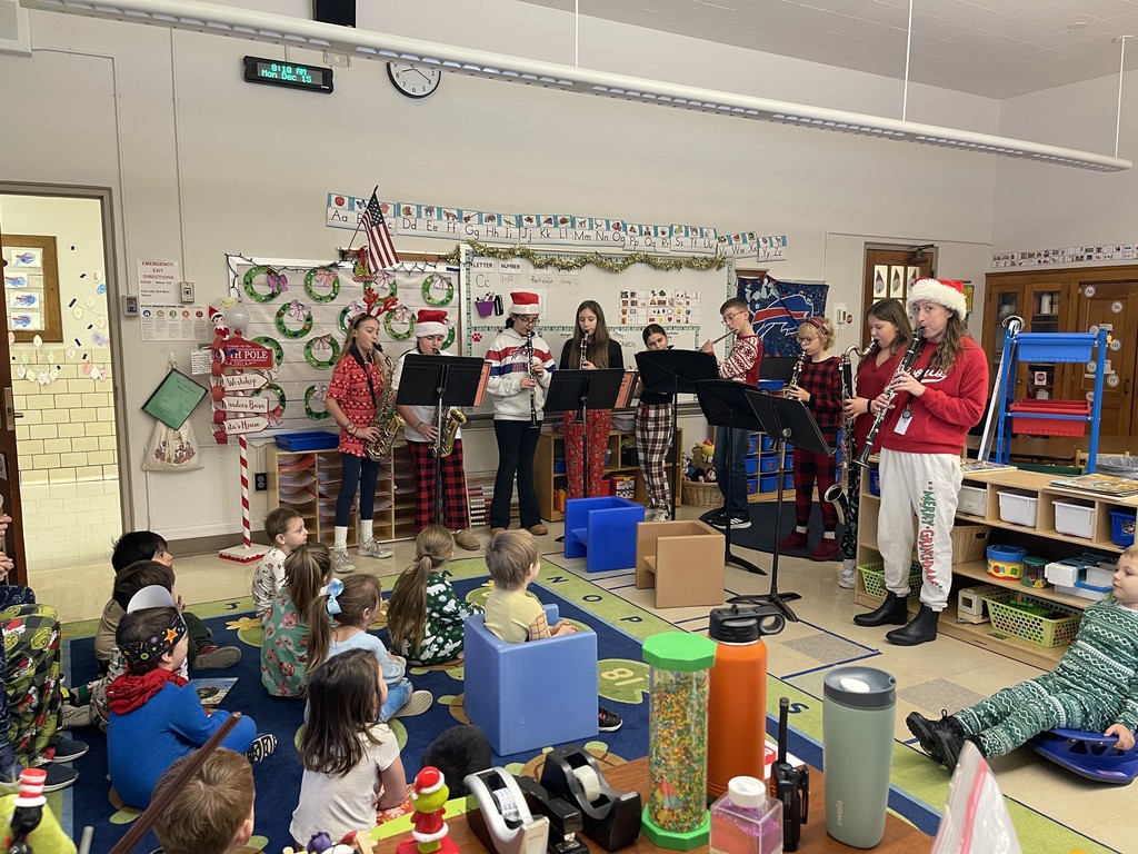 students playing instruments in classroom for younger students