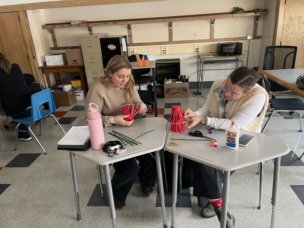 two adults working on crafts