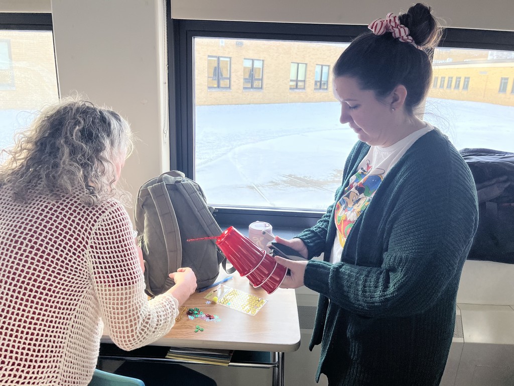 two adults working on crafts