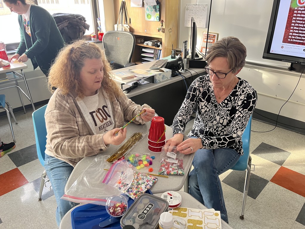 two adults working on crafts