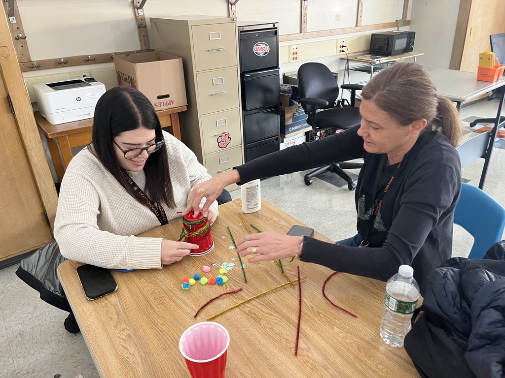 two adults working on crafts