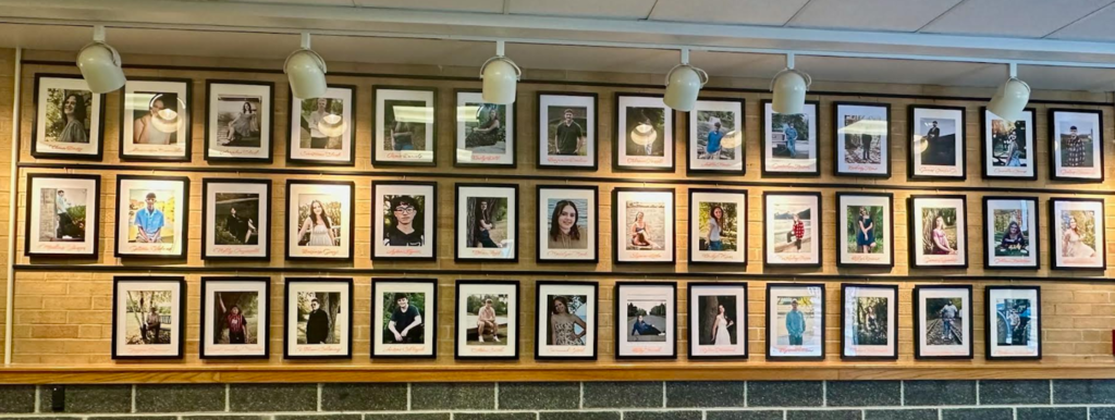 display of senior portraits on wall