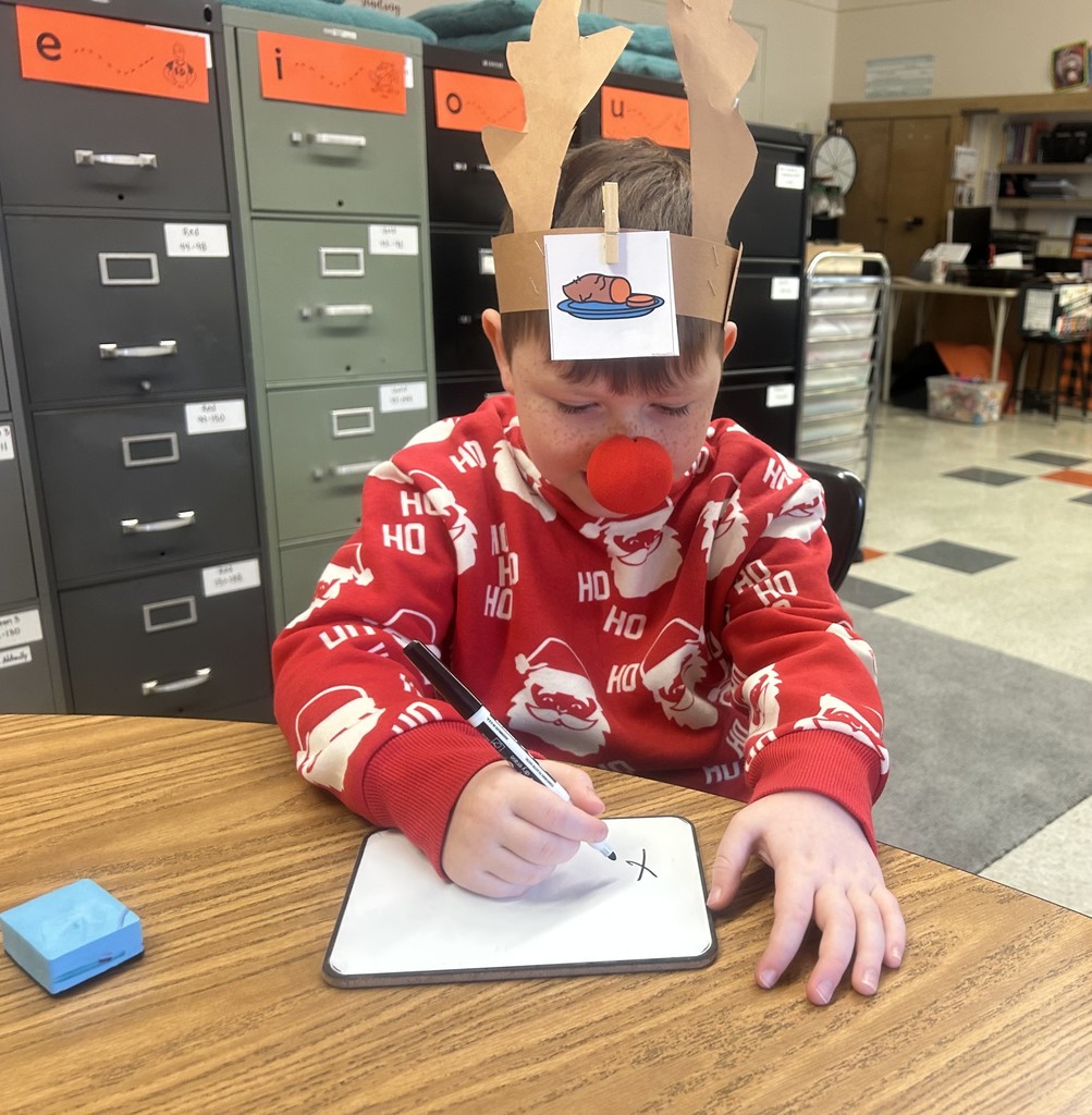 a student writing on a dry erase board