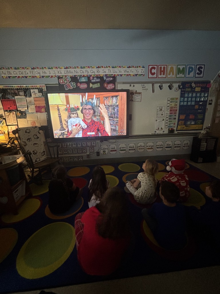 students watching a presenter on smartboard in classroom
