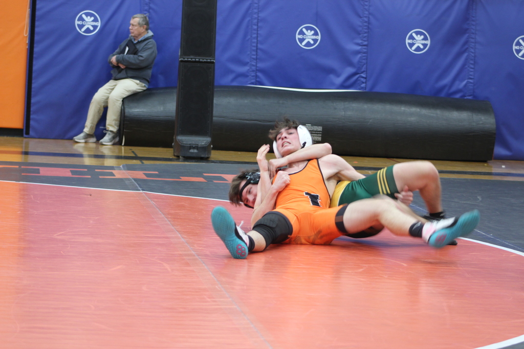 two boys wrestling in gym