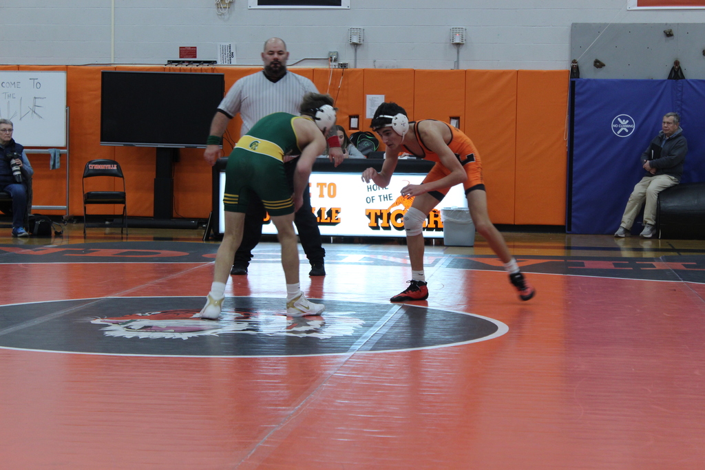 two boys wrestling in gym