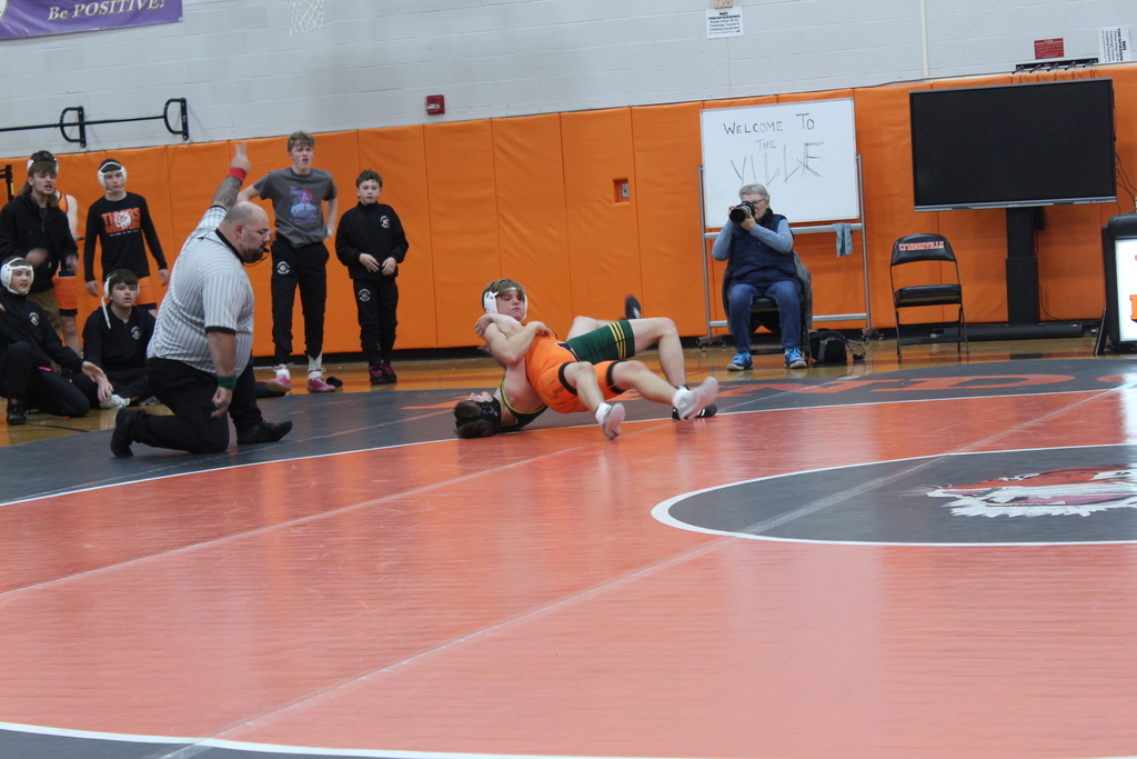 two boys wrestling in gym