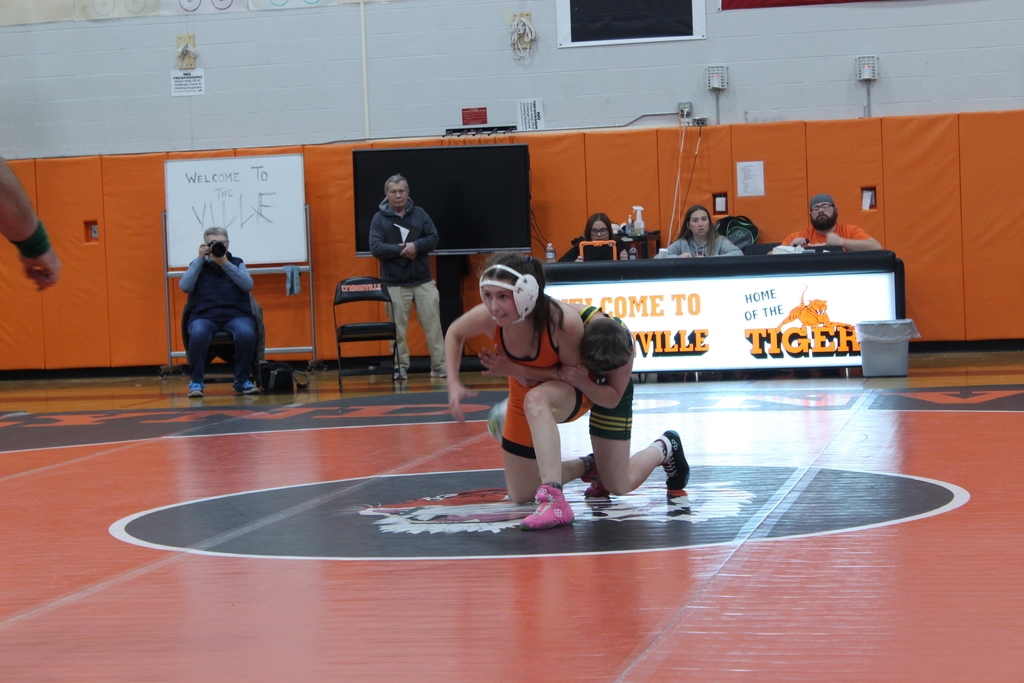 girl and boy wrestling in gym