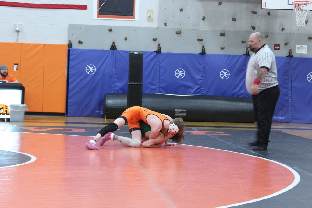 two boys wrestling in gym