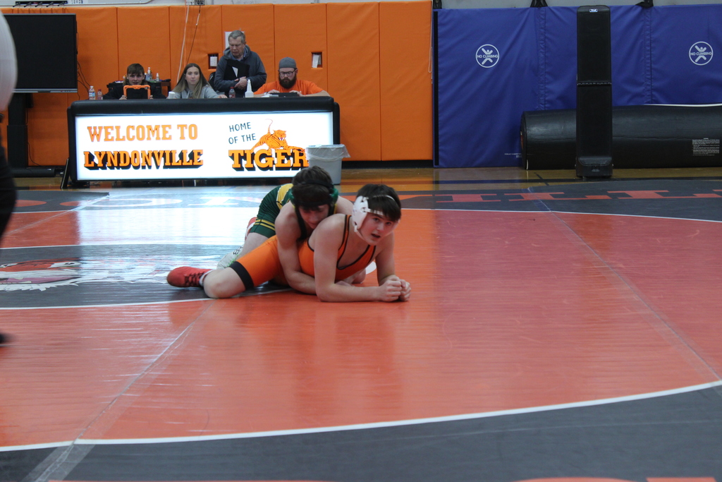 two boys wrestling in gym