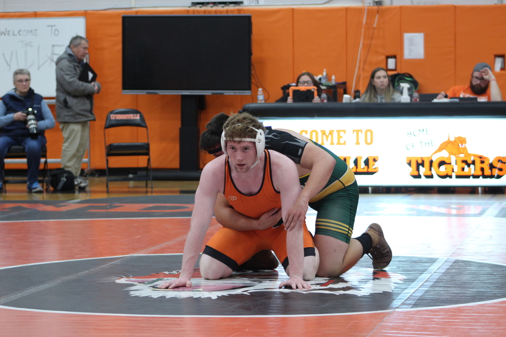 two boys wrestling in gym