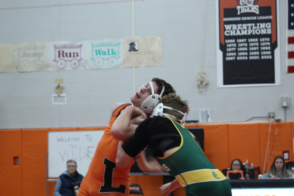 two boys wrestling in gym