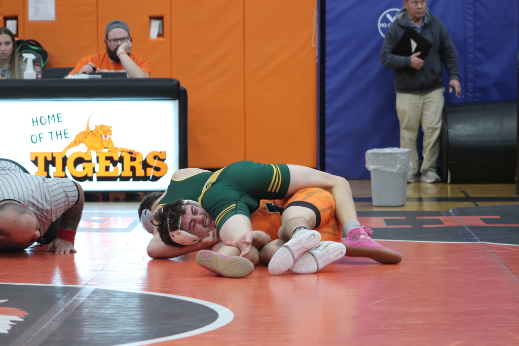 two boys wrestling in gym