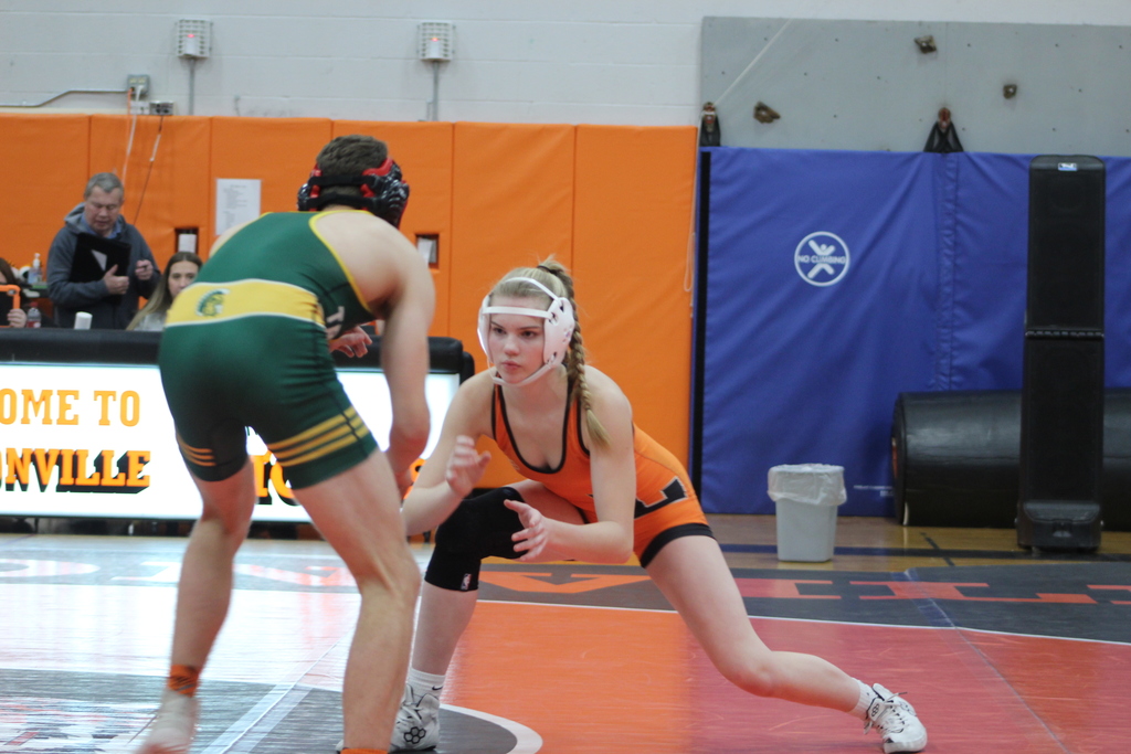a boy and a girl wrestling in gym