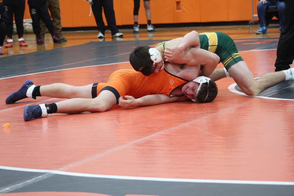 two boys wrestling in gym