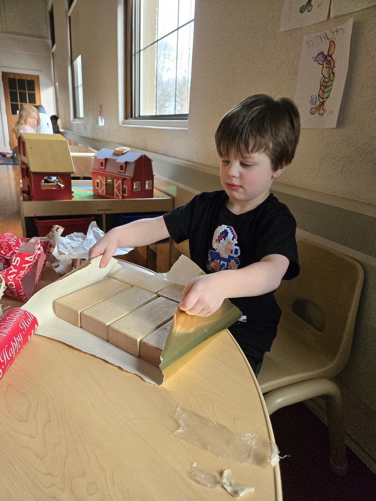 boy wrapping a gift