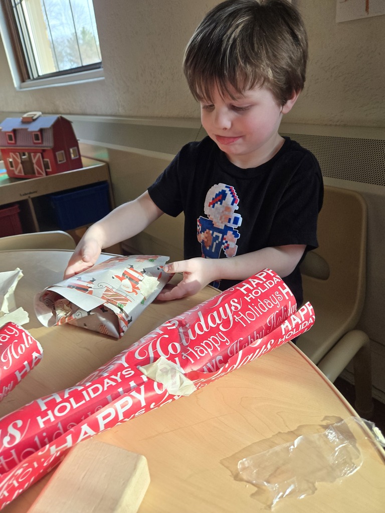 boy wrapping a gift