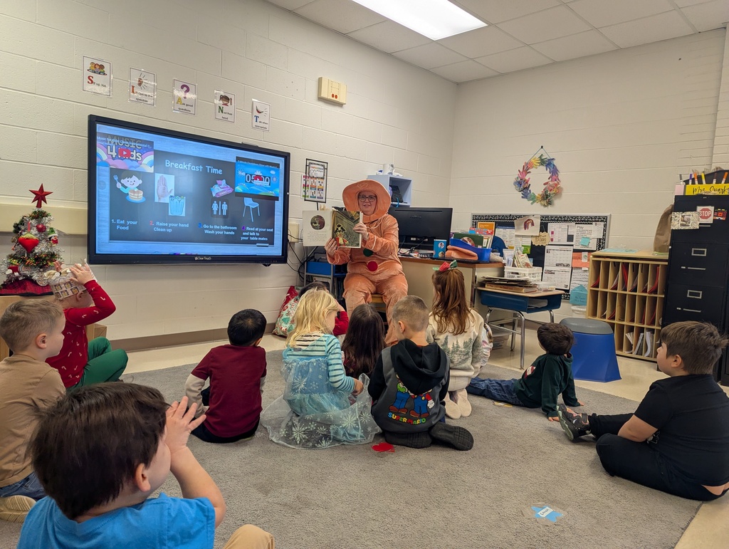 students listening to their teacher read a story