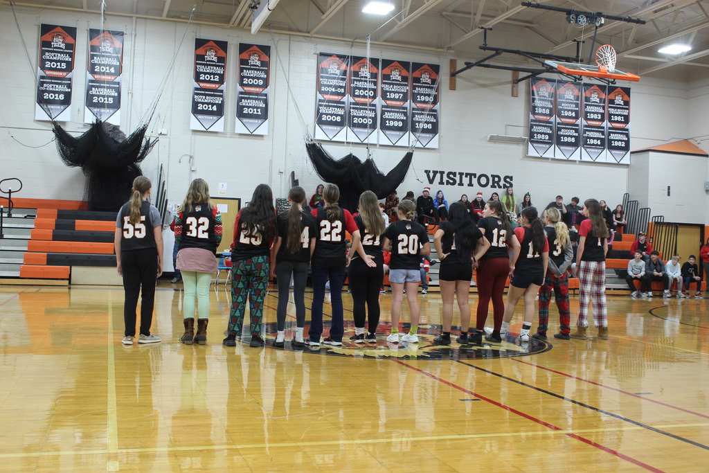 girls team lined up wearing numbered jerseys